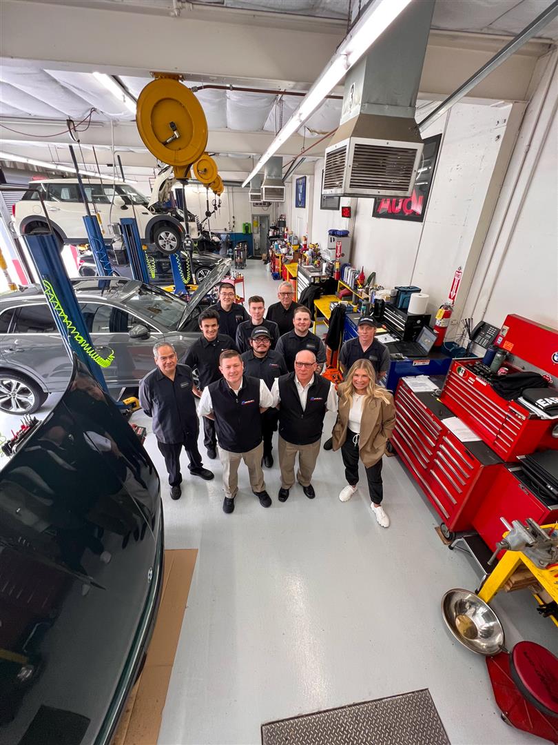Group of Team Posed Inside Garage | M Service Inc.